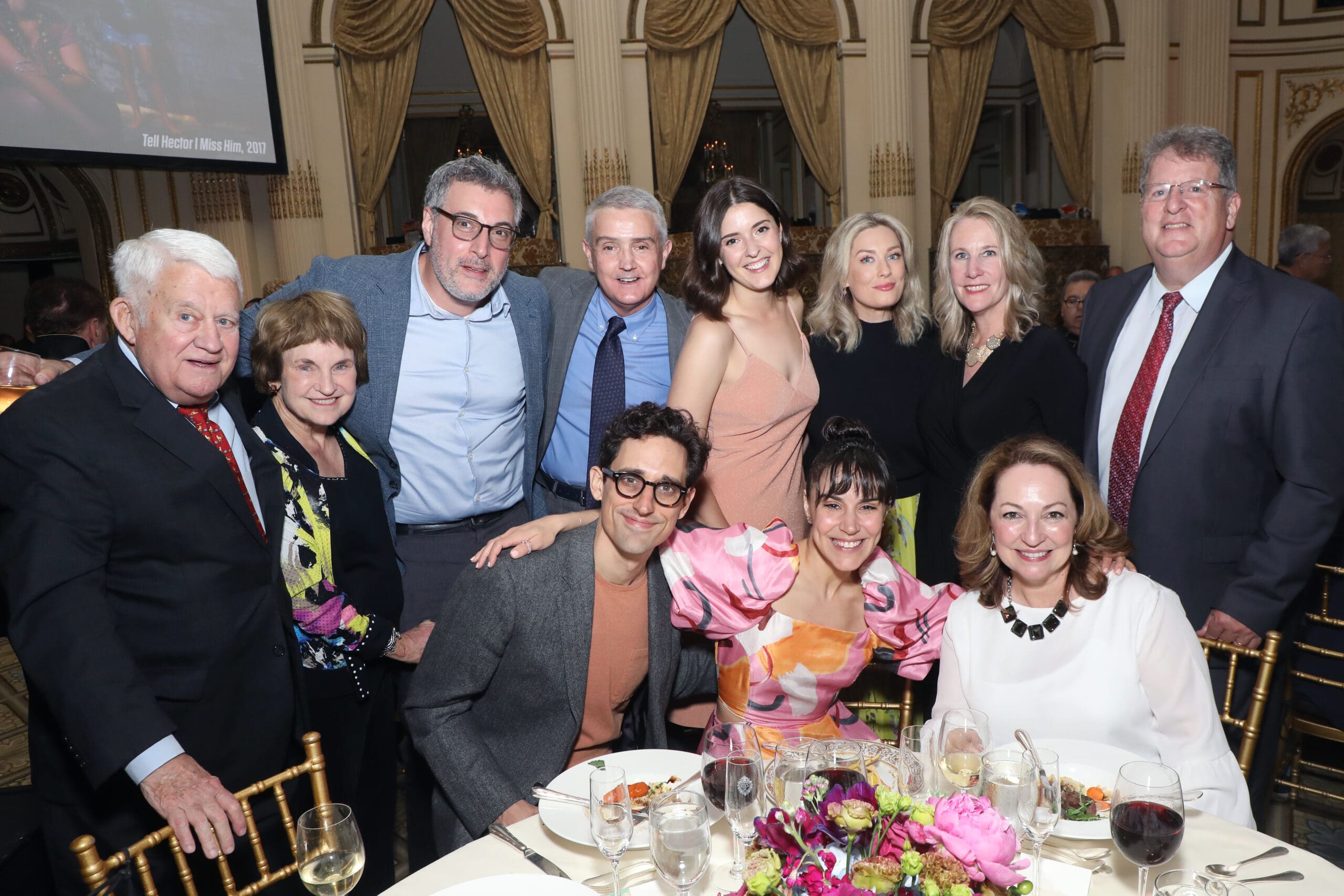 Group photo at an event, including actors and attendees. "Tell Hector I Miss Him" is visible.