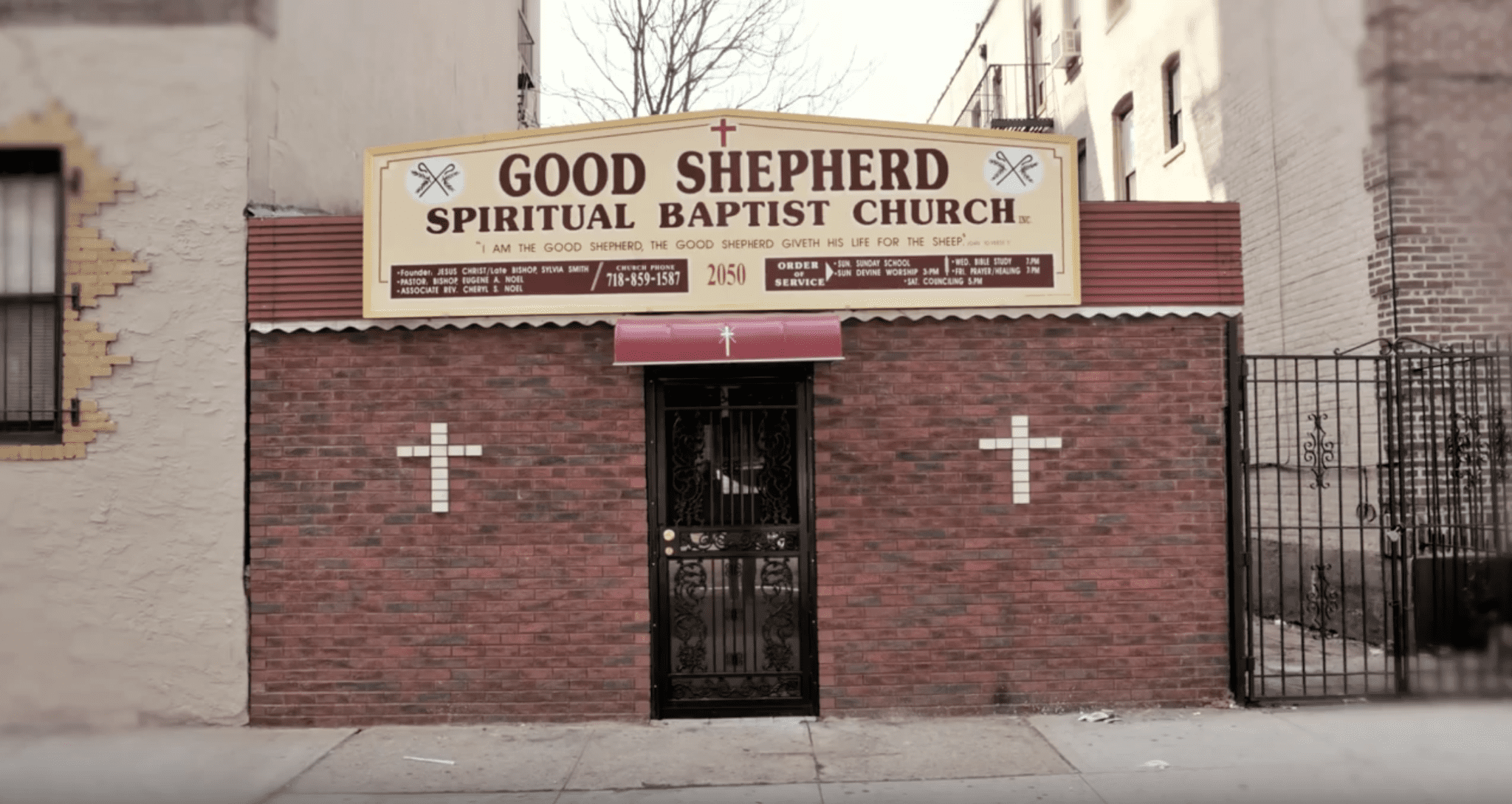 Good Shepherd Spiritual Baptist Church storefront. Brick building with a sign and security door.