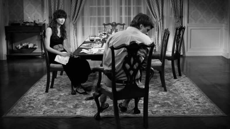 Black and white photo of two people at a dinner table. Dreams of Flying Dreams of Falling.