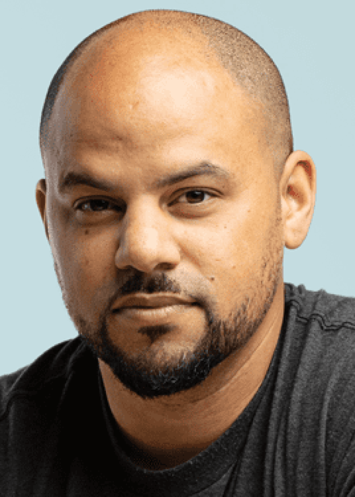 Jelani Memory: Portrait of a bald man with a beard, looking directly at the camera.