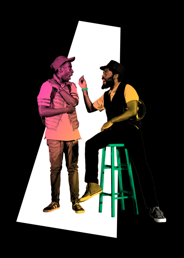 Two men in casual wear having a conversation, one seated on a green stool.