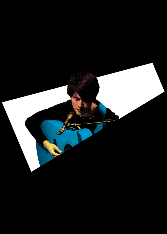 Young man playing a blue acoustic guitar