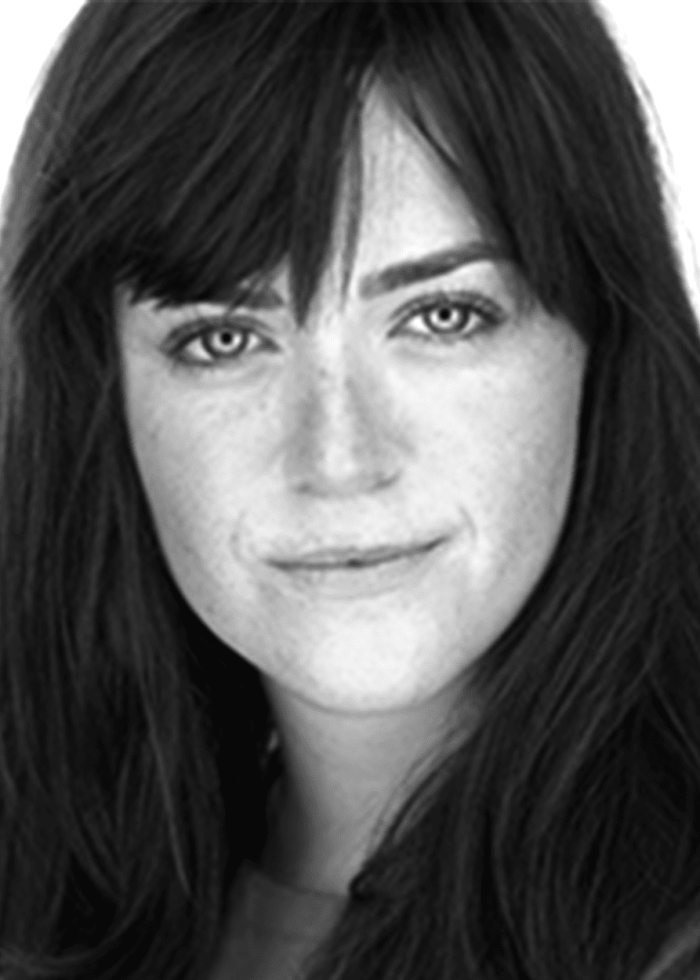 Alison Beatty, headshot with long dark hair and freckles, looking at the camera.