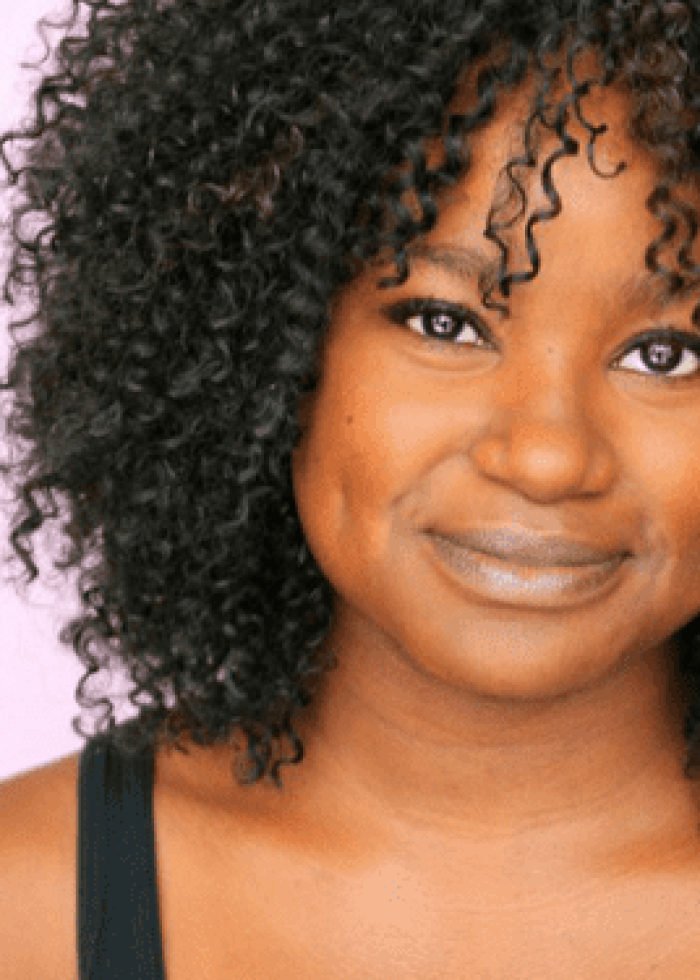 Smiling woman with curly black hair