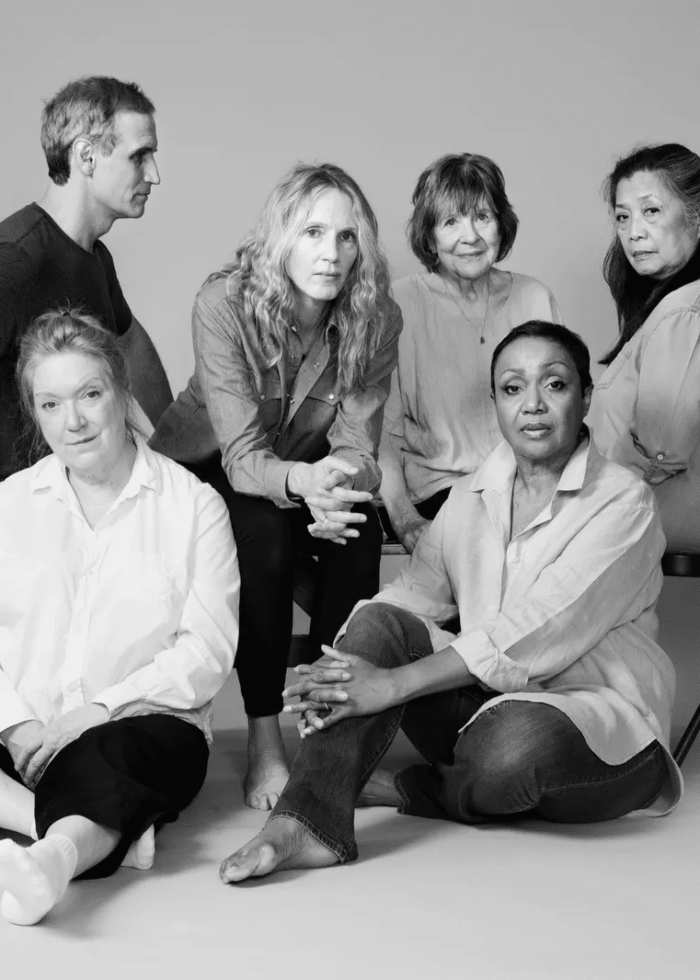 Cast of Annie Baker's "Infinite Life" in a group photo, featuring actors seated and standing.