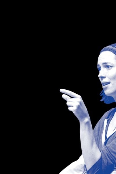 Woman in beanie pointing, profile view