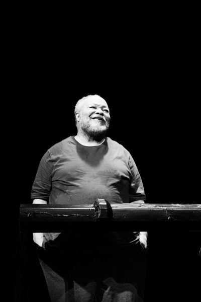 Black and white photo of two actors in "Between Riverside and Crazy," leaning on a dark wooden bar.
