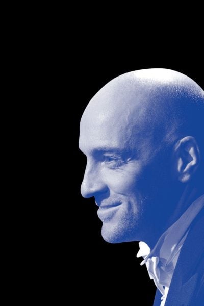 Profile of Derren Brown, subtly smiling.