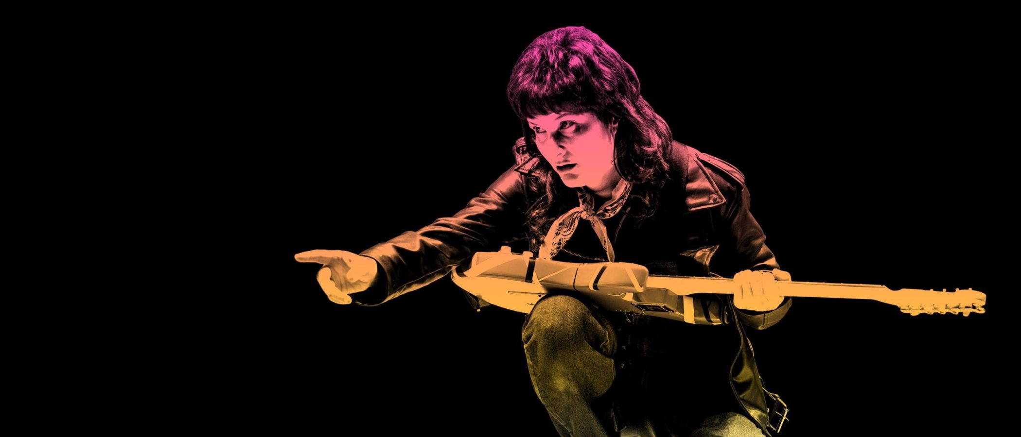 Woman in leather jacket playing electric guitar