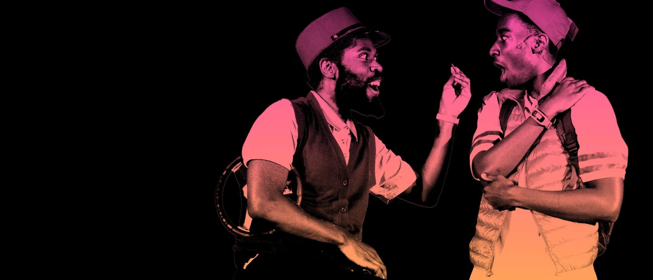2700x1800_Last-Stop_Hero_V1-scaled Two actors in a theatrical performance, one seated, one standing, engaging in animated conversation.