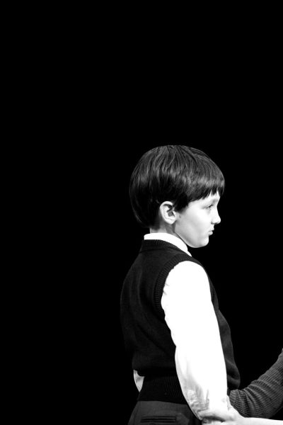 A woman and young boy face each other, the woman looking concerned.