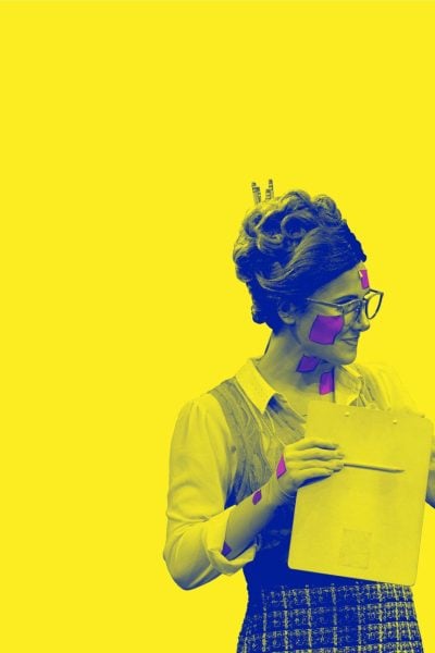 Two women, one in a retro outfit and the other in a lab coat, discuss a clipboard. They have colorful dots on their faces.