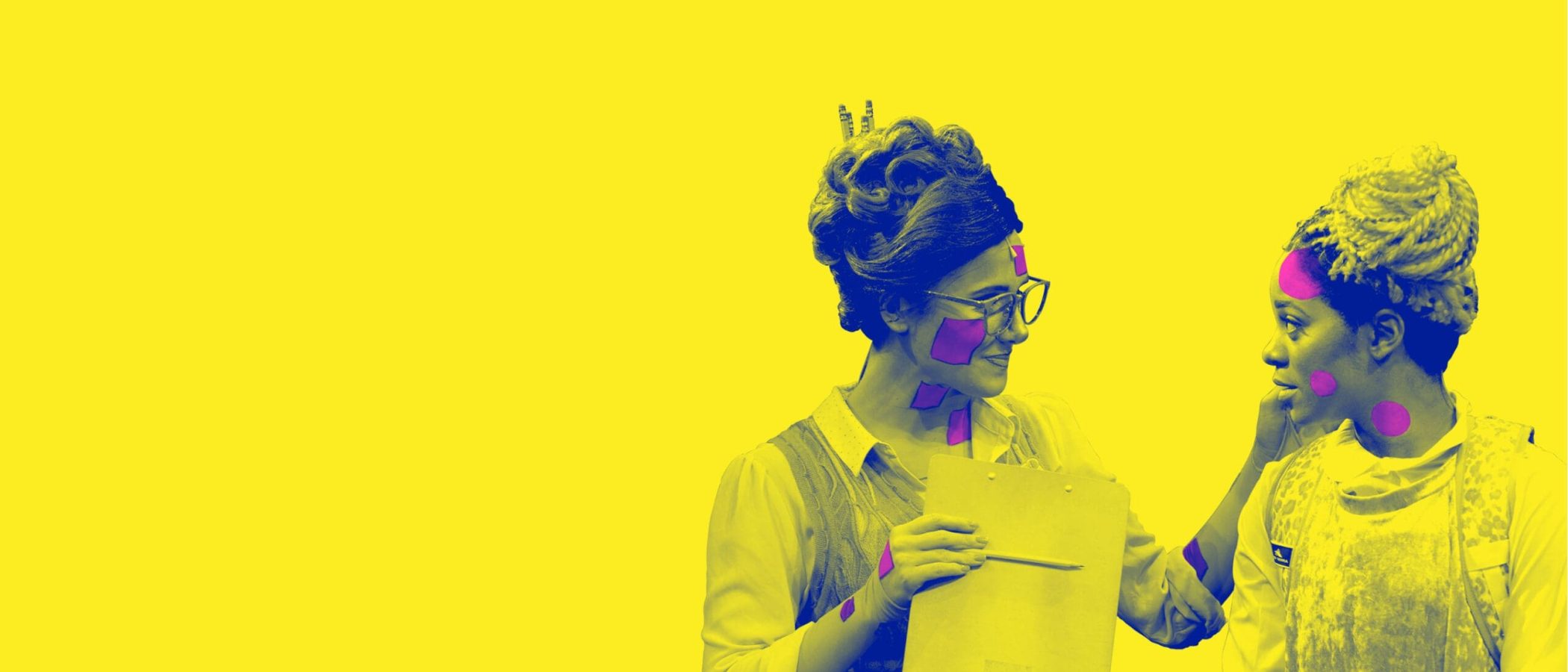 Two women, one in a retro outfit and the other in a lab coat, discuss a clipboard. They have colorful dots on their faces.