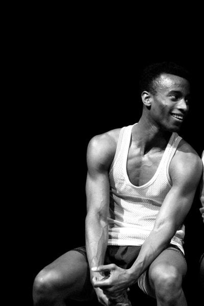 Man and woman sit, looking at each other, possibly reflecting the loneliness theme.