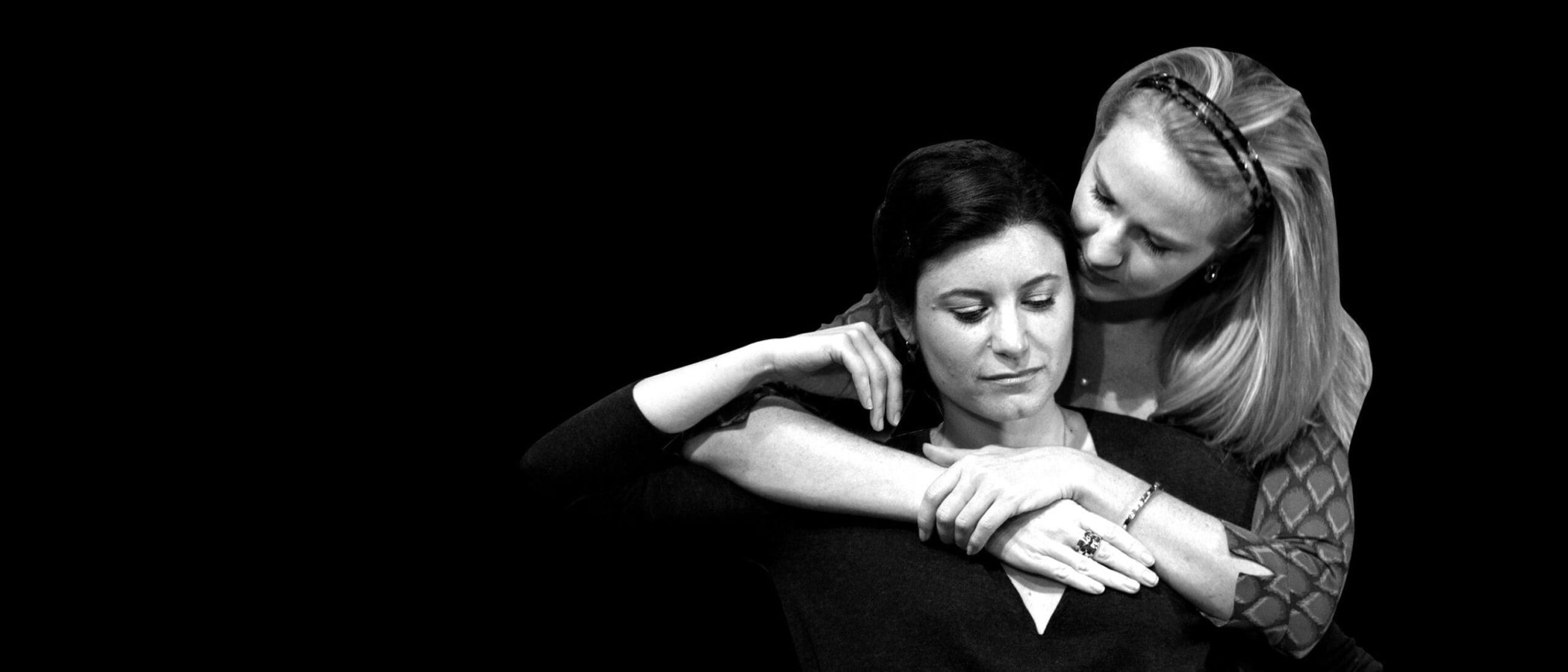 Two women embracing, one comforting the other. Women or Nothing.