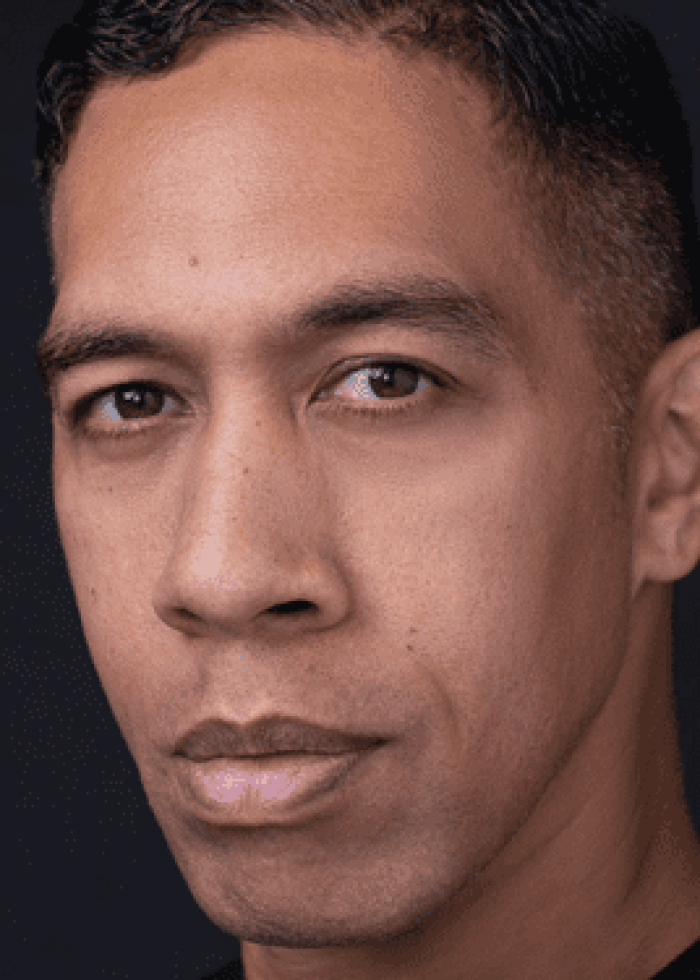 Moses Goods, actor and playwright, looking directly at the camera.