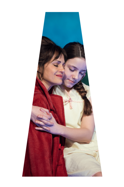 A mother and daughter embrace, eyes closed, conveying comfort and love.