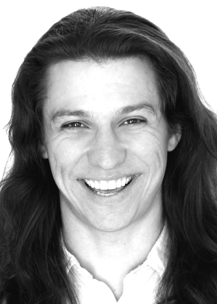 Armando Gutierrez smiling with long hair