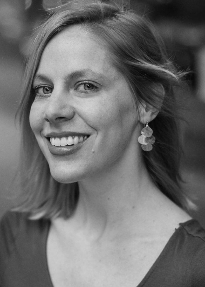 Smiling woman with layered earrings, portrait