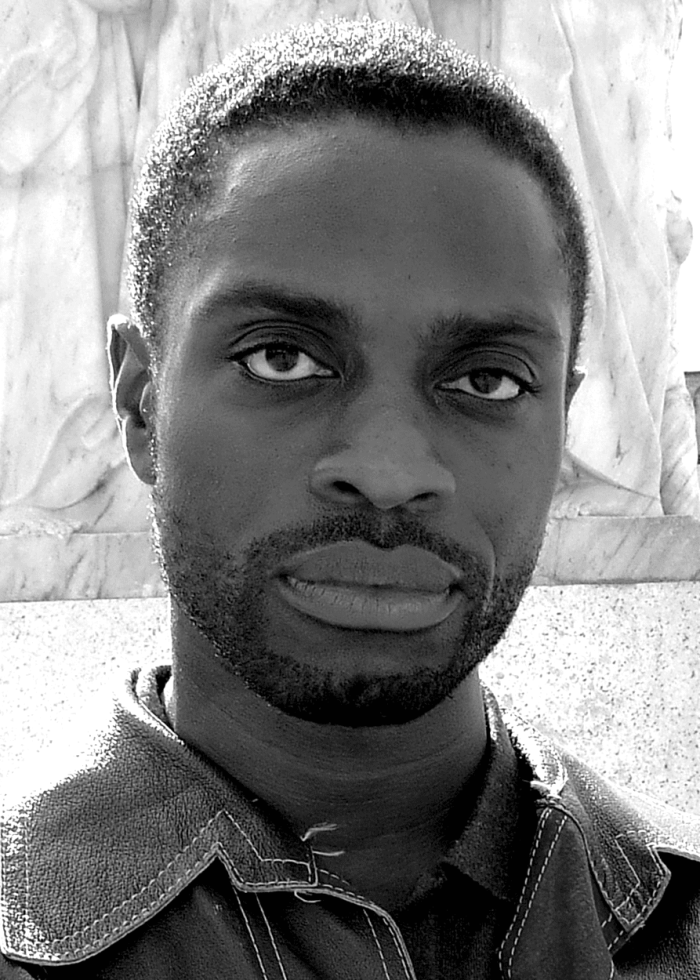 Adesola Osakalumi, close-up portrait, looking directly at the camera.