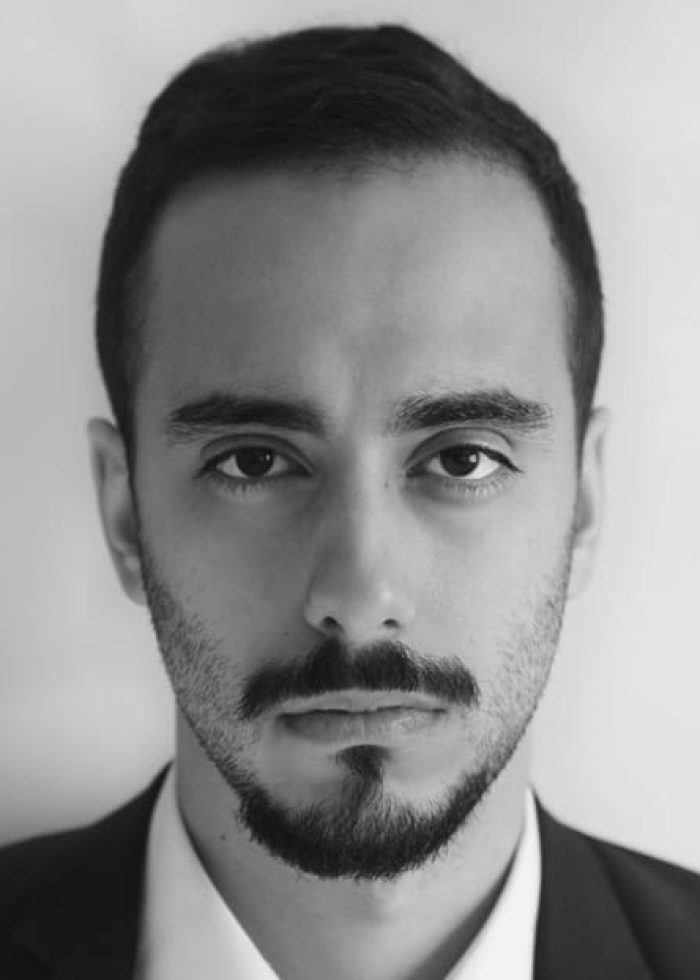 Close-up portrait of Pedro Aijon, a man with a beard, in a suit.