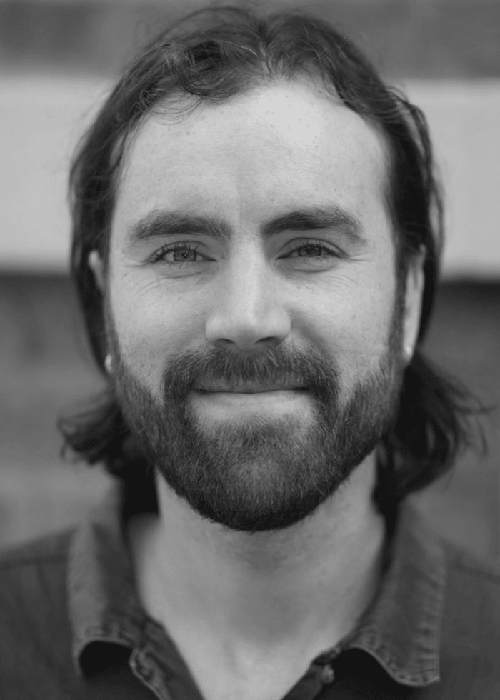 Alden Harris-McCoy with a beard smiles at the camera