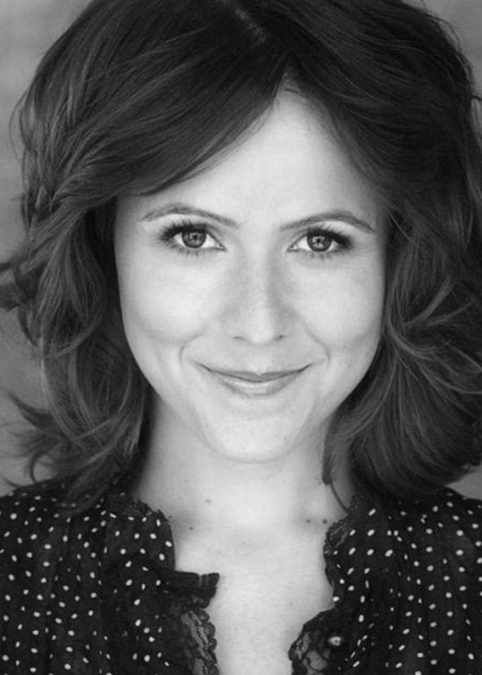 Alli Mauzey smiling, wearing a polka dot shirt