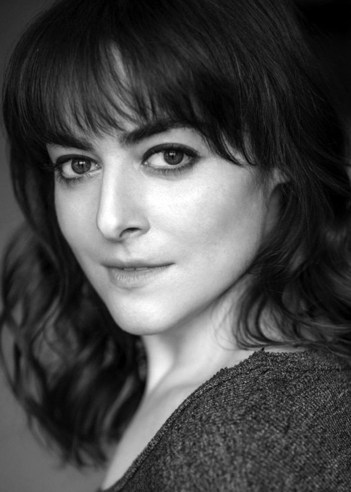 Amanda Corday, portrait in black and white, looking at the camera.