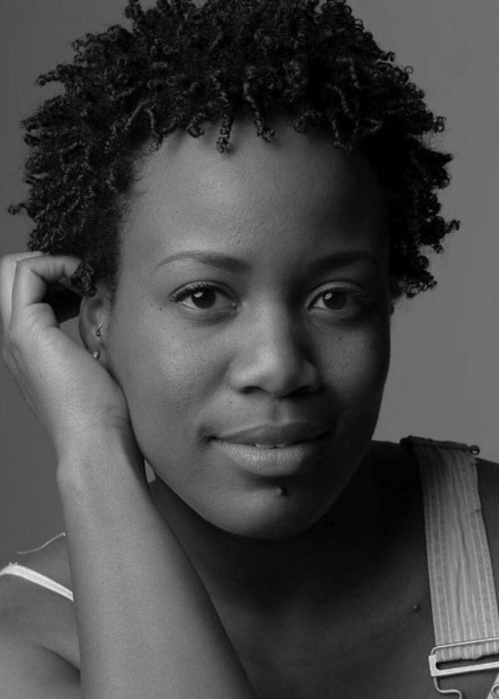 Anastacia McCleskey in a black and white portrait, smiling