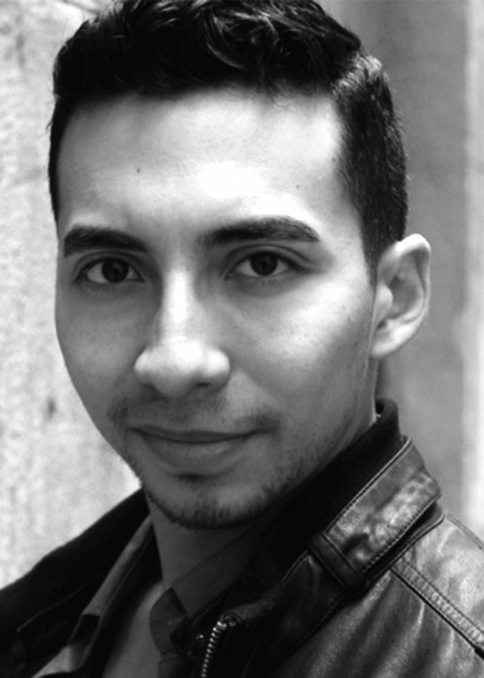 Andrew-mayer Andrew Mayer looking at the camera, wearing a leather jacket