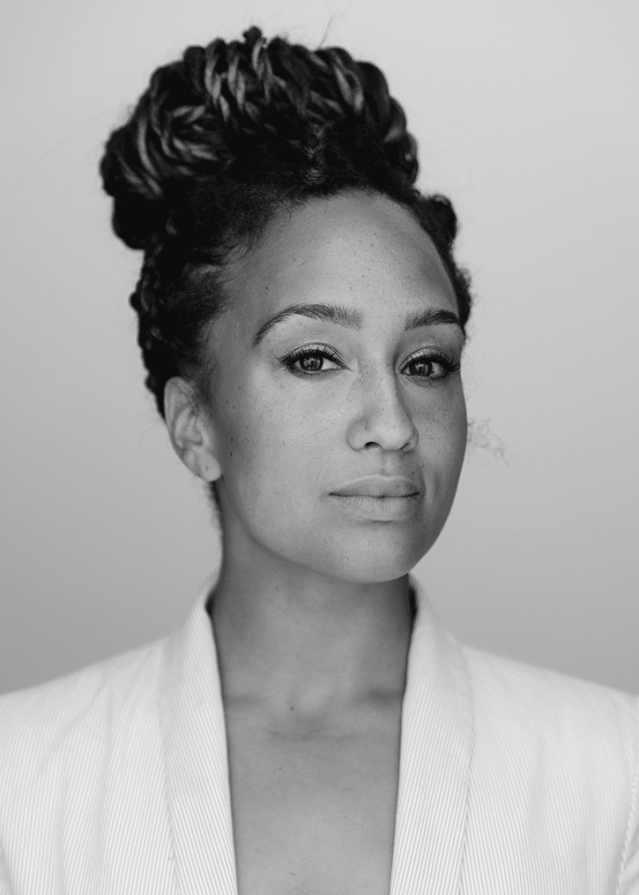 Black and white portrait of a woman with her hair up, wearing a blazer.