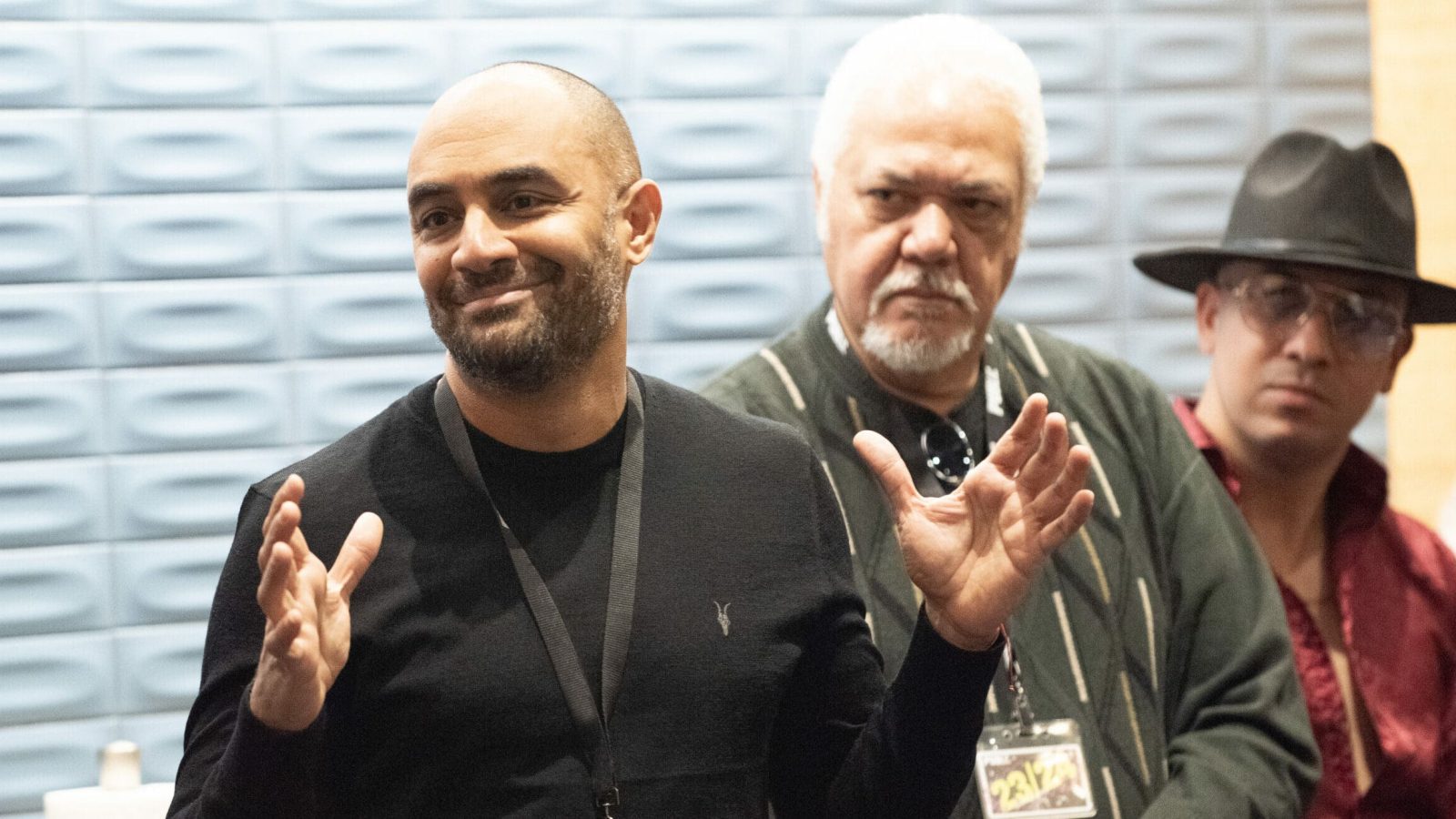 Three men, one gesturing, at a Buena Vista Social Club event.