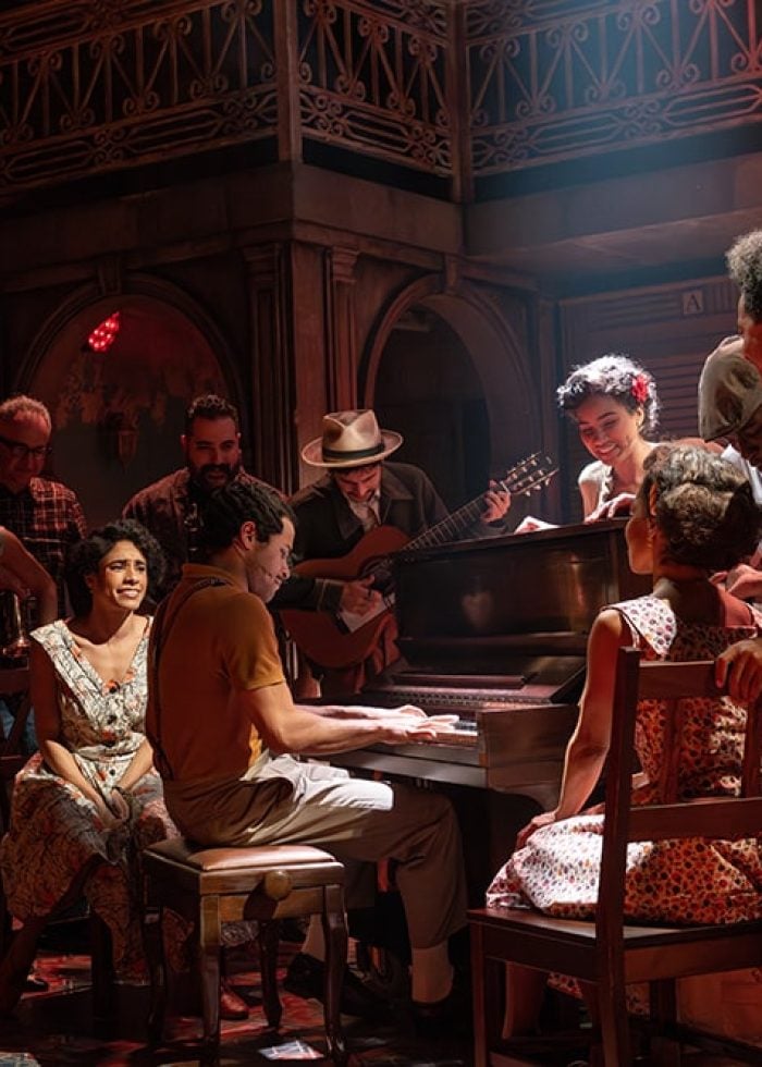 a group of people around a piano