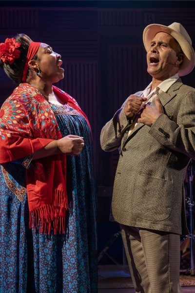 Two singers perform a duet, reminiscent of the Buena Vista Social Club's style.