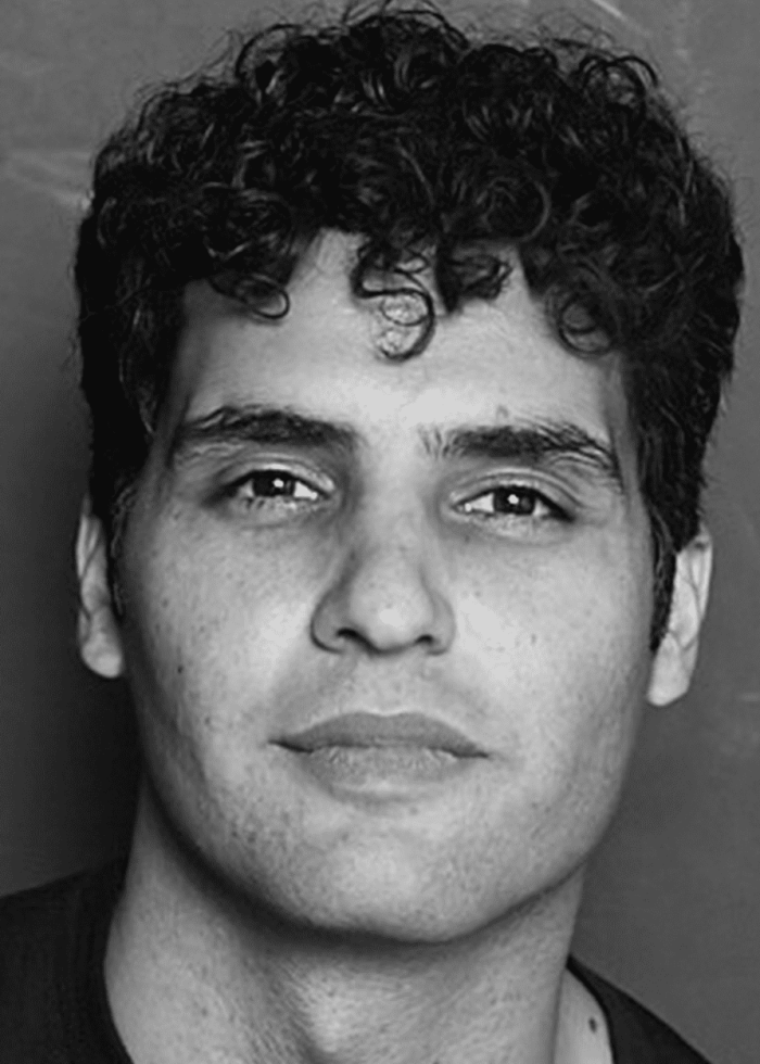 Babak Tafti, actor, looking directly at the camera in a black and white portrait.