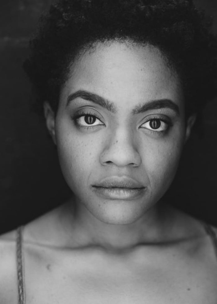 Close-up portrait of Gabby Beans with short, natural hair, looking directly at the camera.