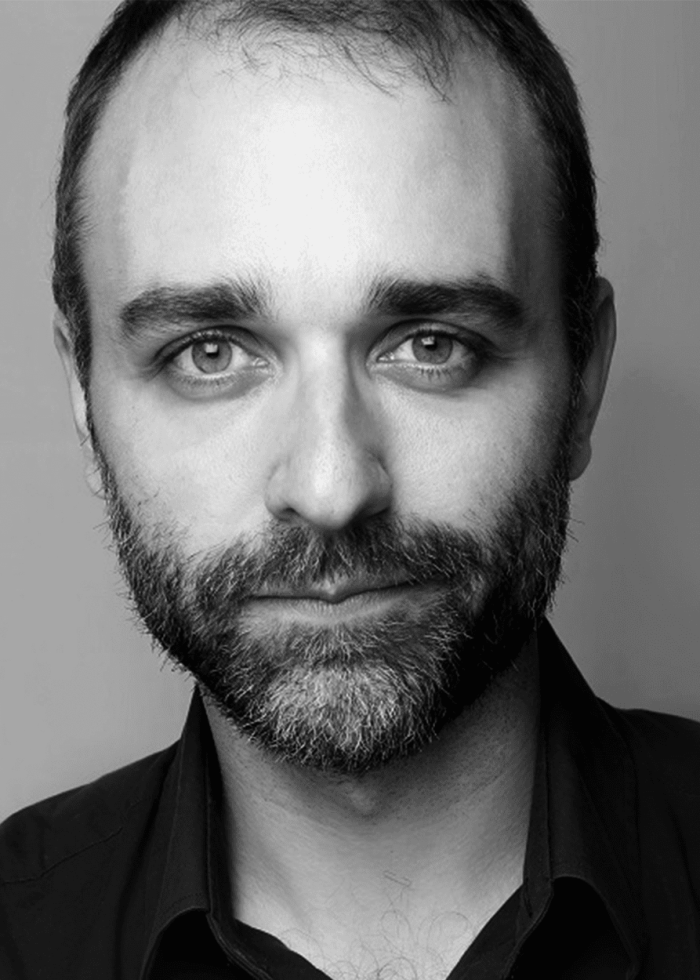 Ben Beckley: Portrait of a man with a beard, looking directly at the camera.