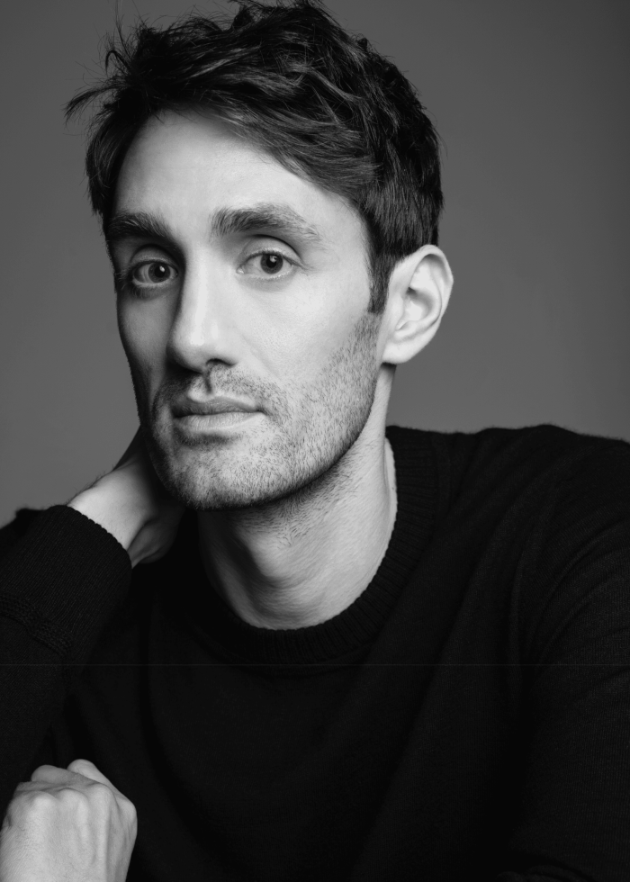 Ben Chase portrait, black and white headshot of a man looking at the camera.