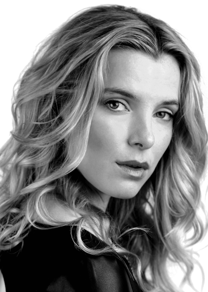 Betty Gilpin in a black and white portrait, looking at the viewer