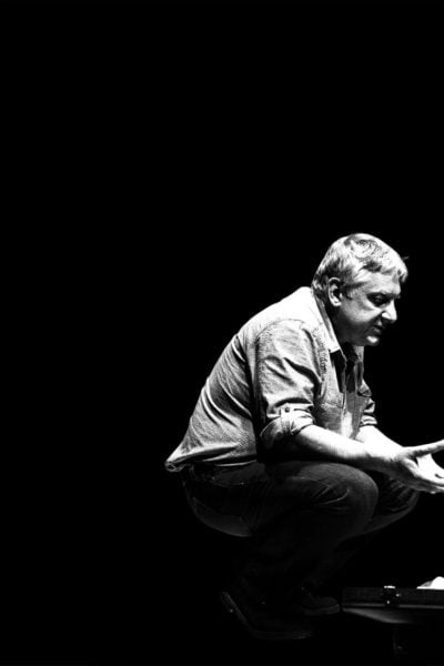 Black and white photo of a man and woman in conversation.