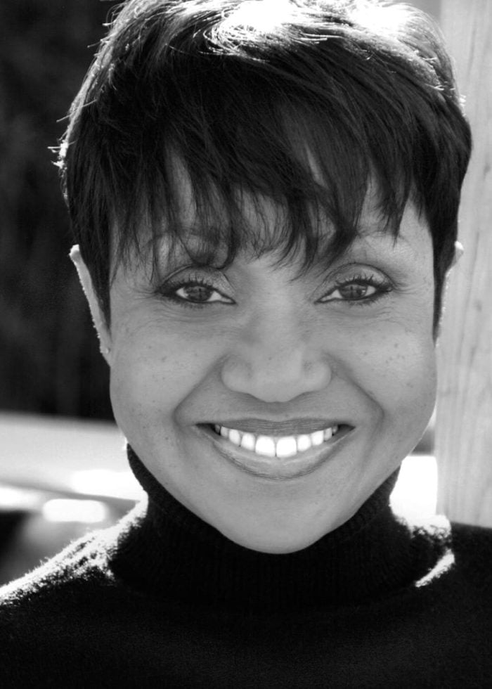 Brenda Pressley smiling, wearing a black turtleneck sweater