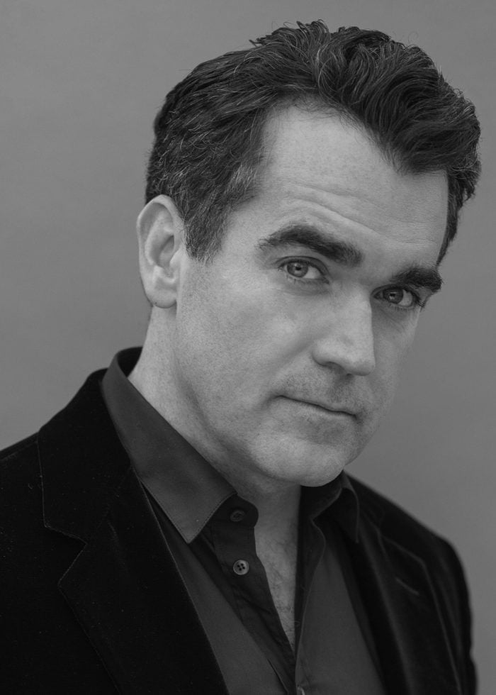 Brian d'Arcy James looking at the camera in a black and white portrait.