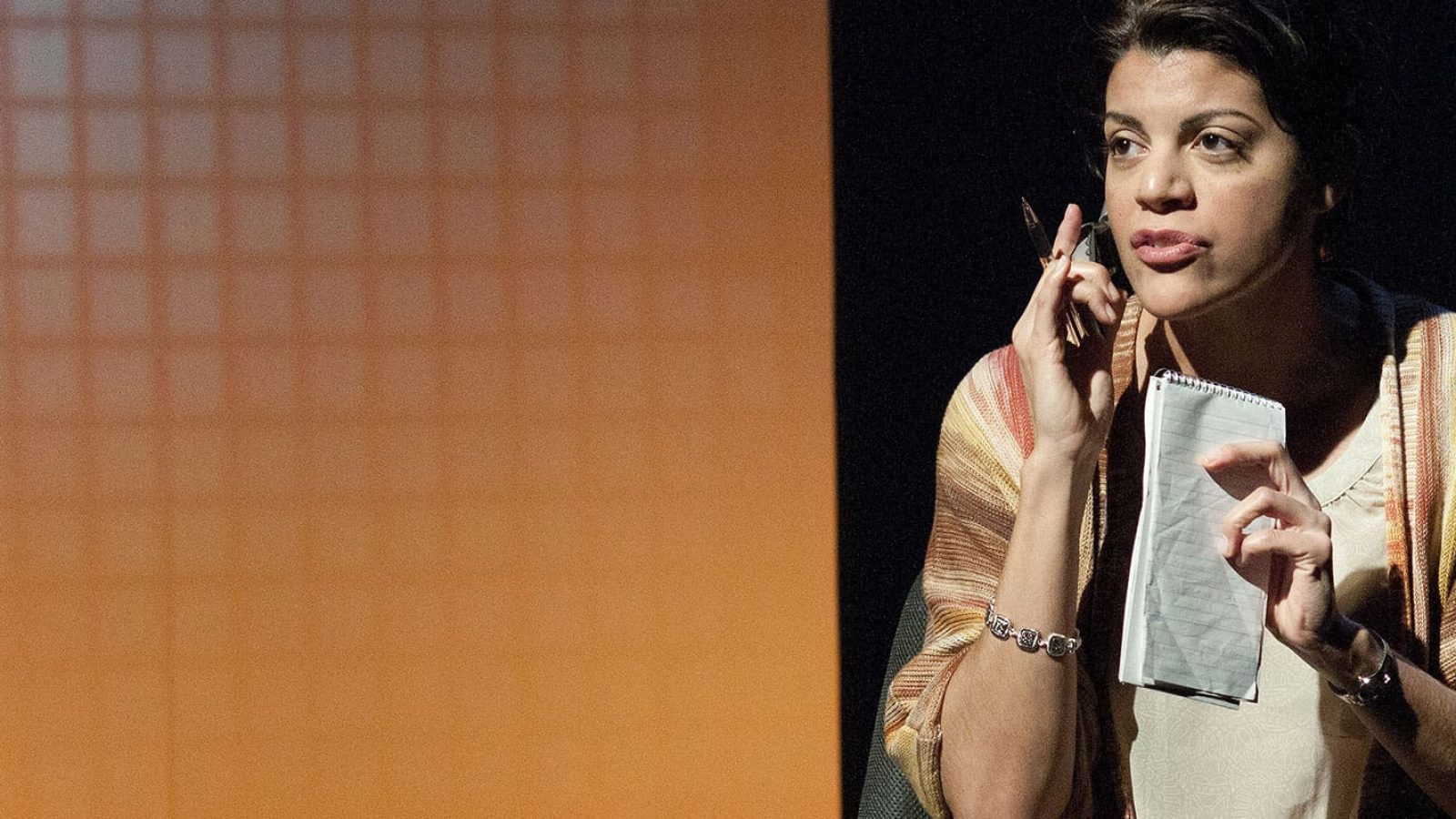 Woman on phone, taking notes, thoughtful expression. CQ/CX concept.