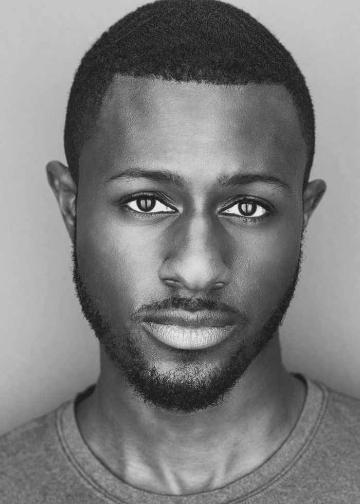 Close-up portrait of Cameron Amandus, a man with short hair and a beard.
