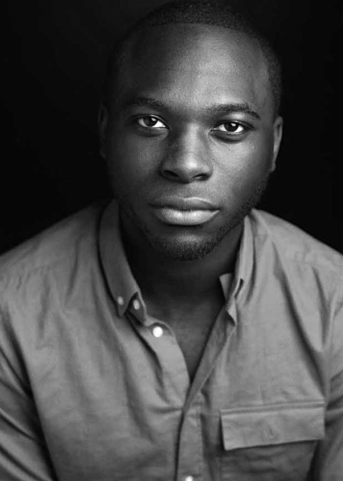 Carl Bryant, headshot in black and white, wearing a button-down shirt.