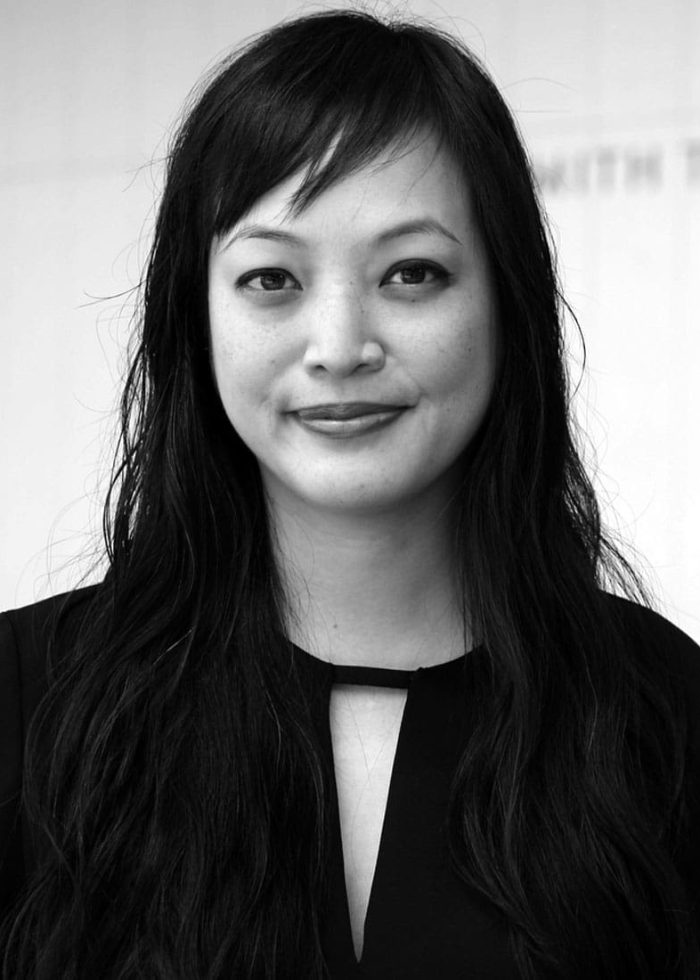 Portrait of a woman with long dark hair, wearing a black top.