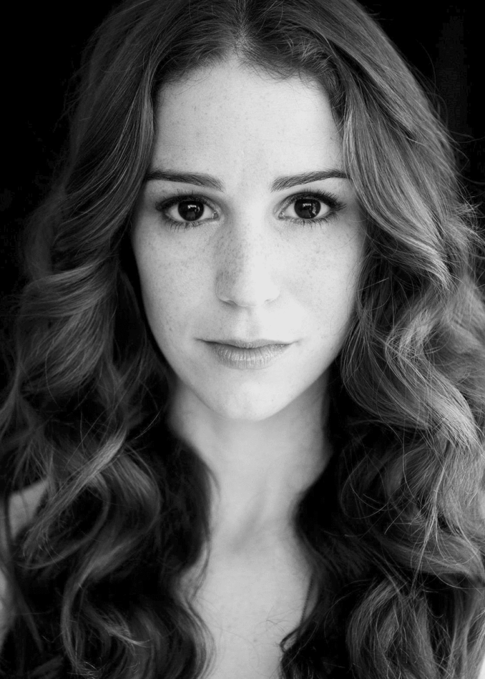Chilina Kennedy, actress, with long wavy hair and freckles, looking directly at the camera.