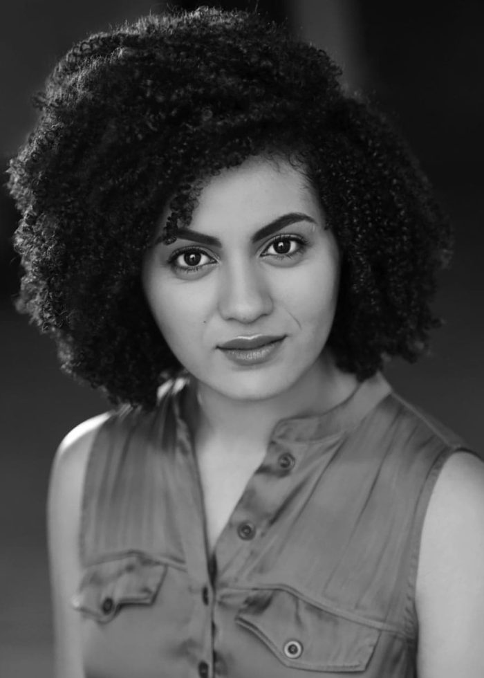 China Brickey portrait: Woman with curly hair looking at the camera