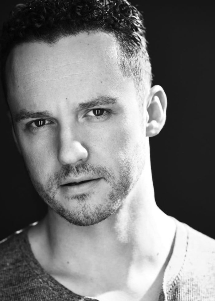 Christopher Cassarino in a black and white headshot, looking directly at the camera.