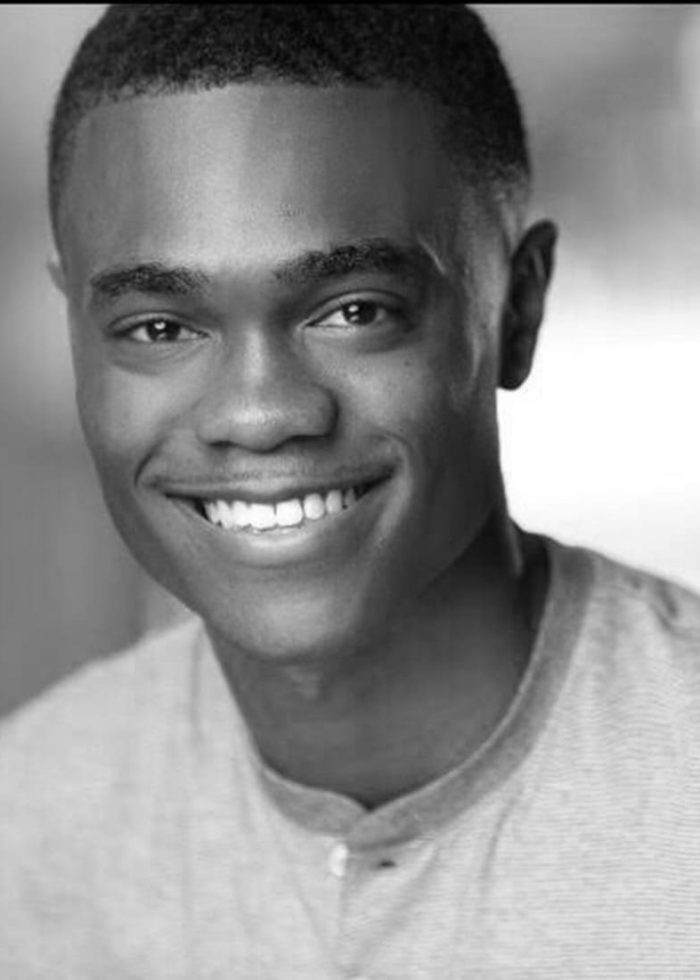 Headshot of a smiling young Black man, Christian Strange